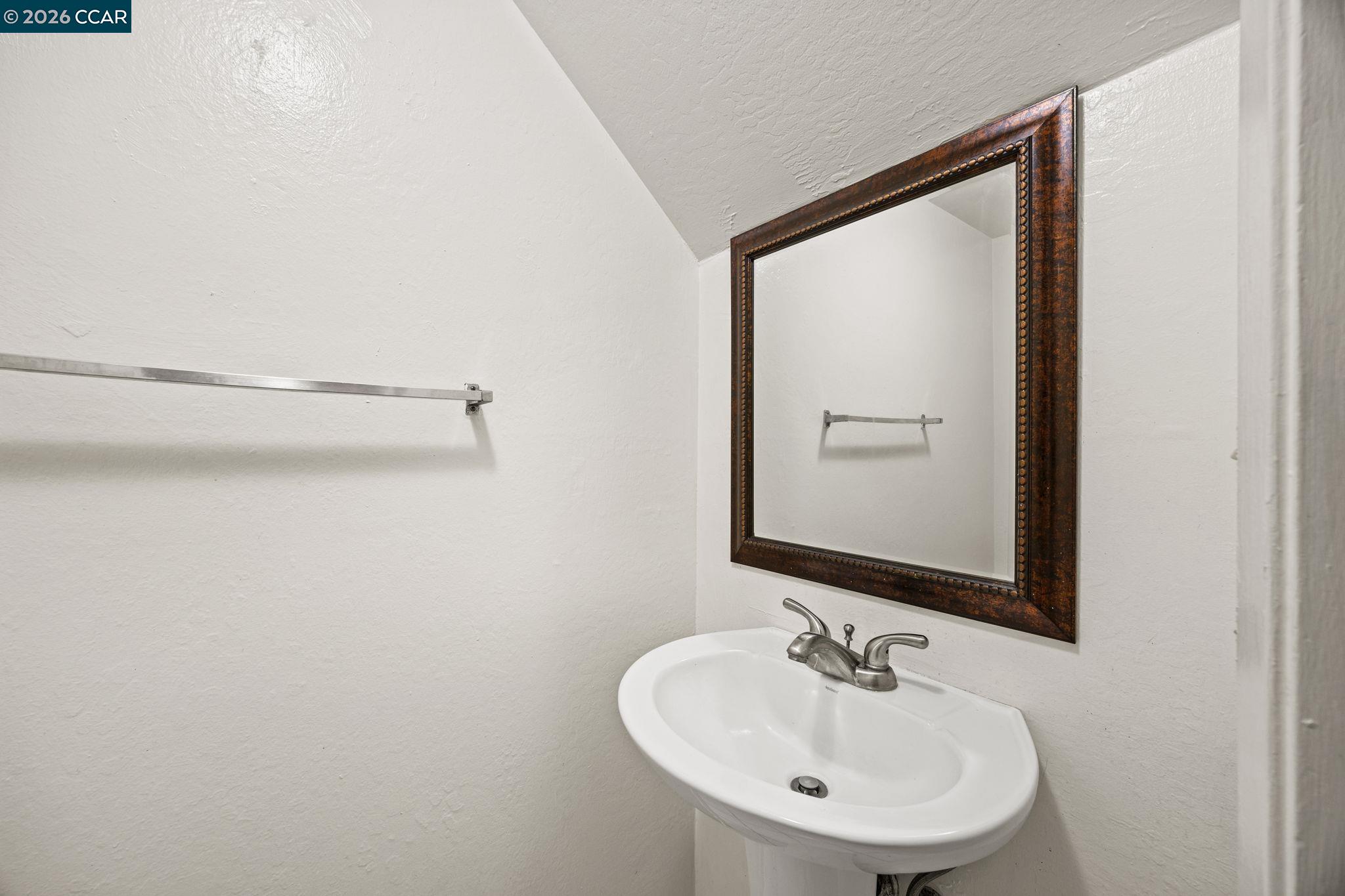 2069 Olivera Road, Unit E Concord, CA 94520 - Photo 13 of 18 a bathroom with a sink and a mirror