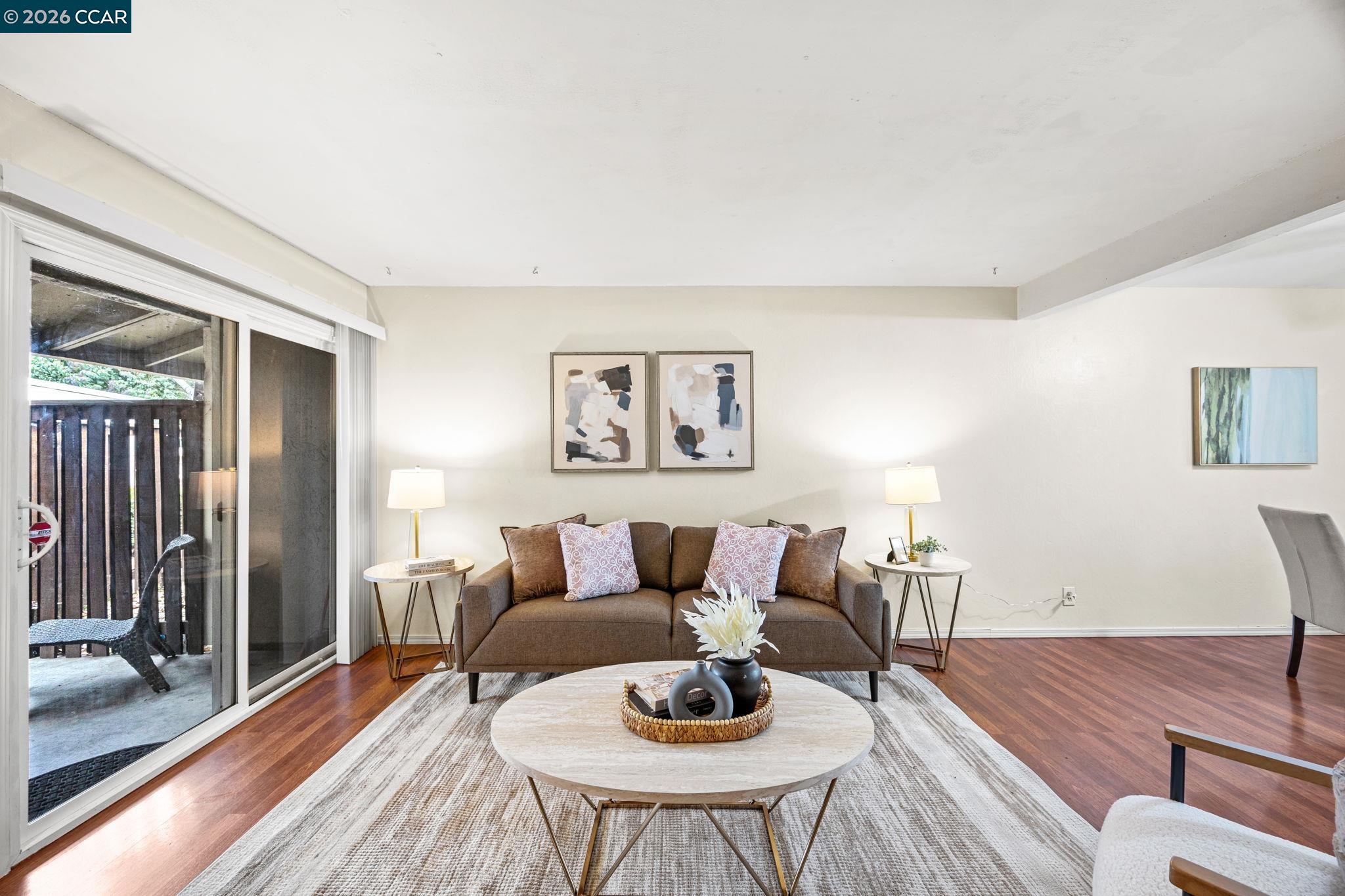 2069 Olivera Road, Unit E Concord, CA 94520 - Photo 3 of 18 a living room with furniture and wooden floor