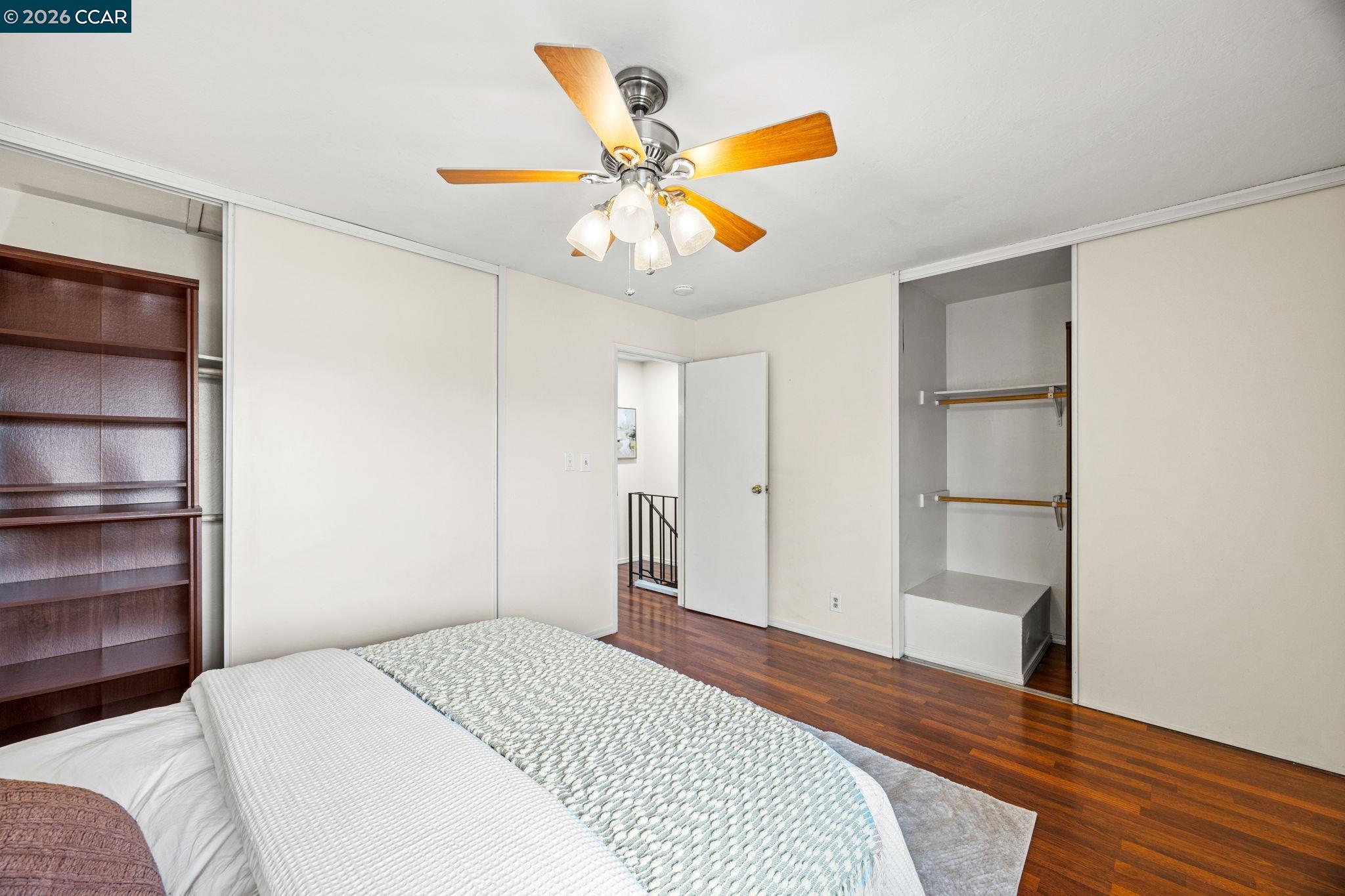 2069 Olivera Road, Unit E Concord, CA 94520 - Photo 7 of 18 a bedroom with a bed and a chandelier