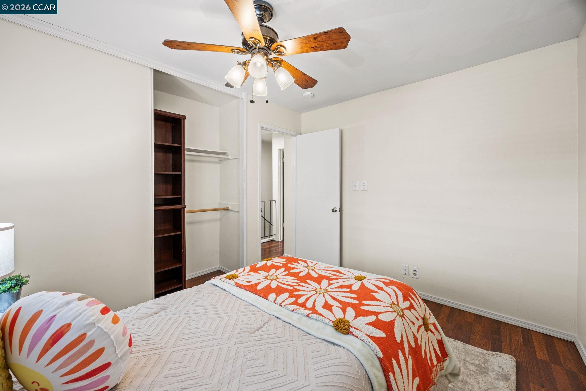 2069 Olivera Road, Unit E Concord, CA 94520 - Photo 10 of 18 a bedroom with a bed and a chandelier