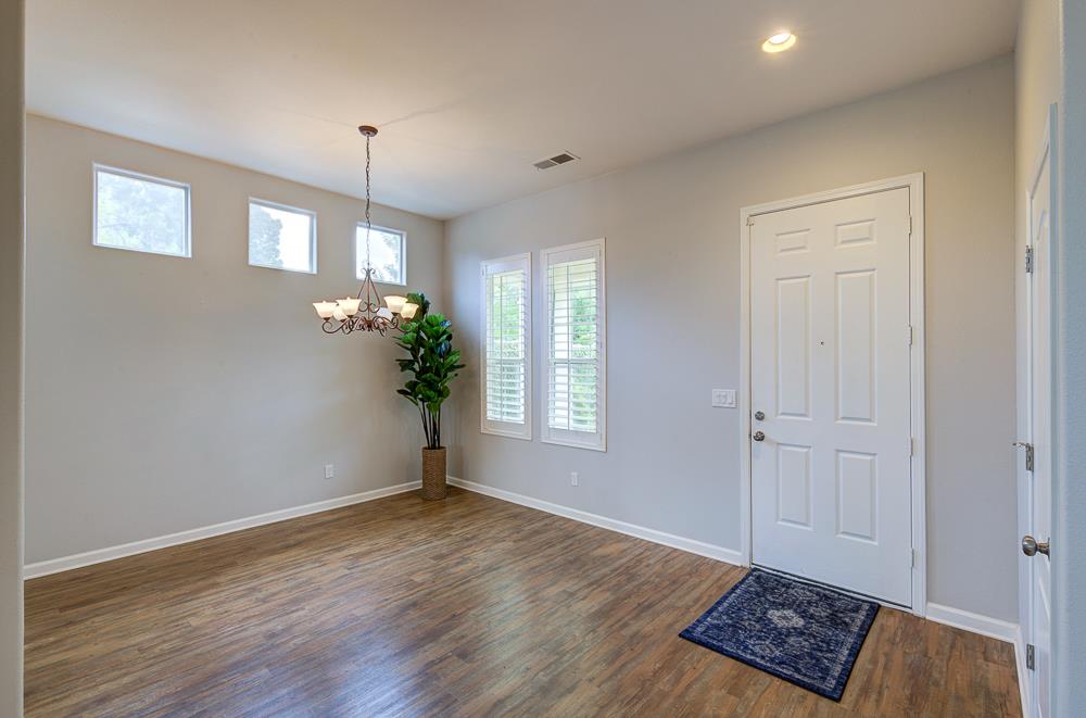 3235 Rall Avenue Clovis, CA 93619 - Photo 8 of 33 a view of an empty room with window and wooden floor