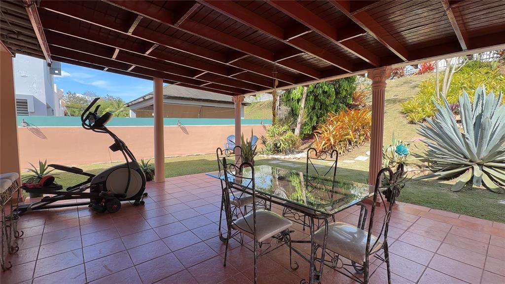 1 St Rio Grande, Unit B6 Rio Grande, PR 00745 - Photo 6 of 47 a couple of chairs and a table in patio with a glass door
