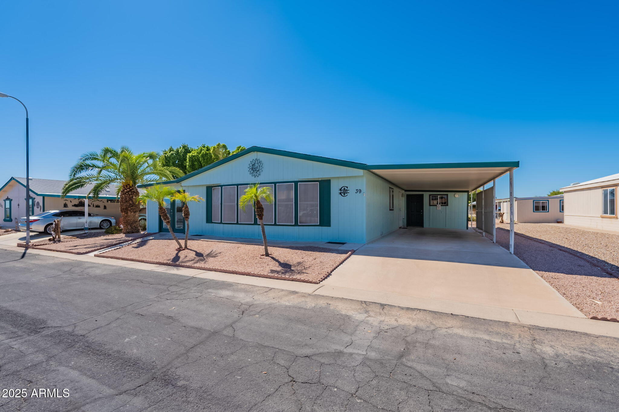 3700 South Tomahawk Road, Unit 39 Apache Junction, AZ 85119 - Photo 11 of 53 a view of a house with backyard and sitting area