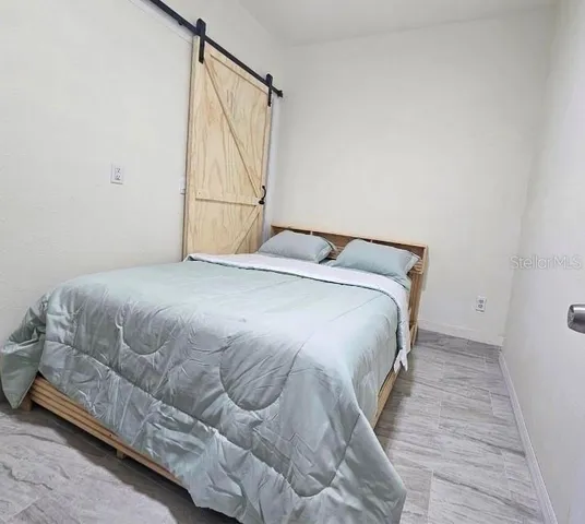 a bedroom with a bed and a window