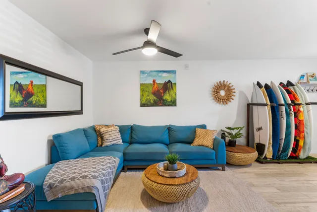 a living room with furniture a rug and a wall painting