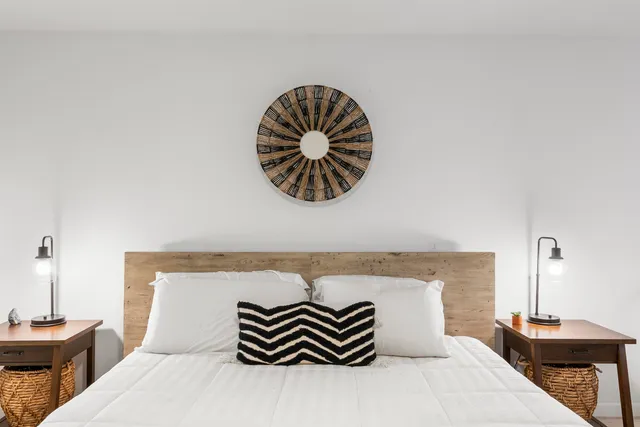 a bedroom with a bed and a potted plant