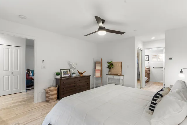 a bedroom with a bed and wooden floor