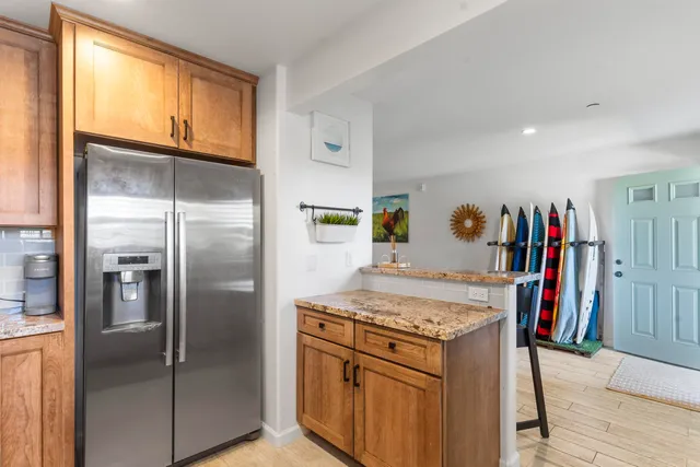 a kitchen with a refrigerator and a sink