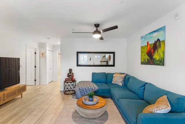 a living room with furniture and a wooden floor