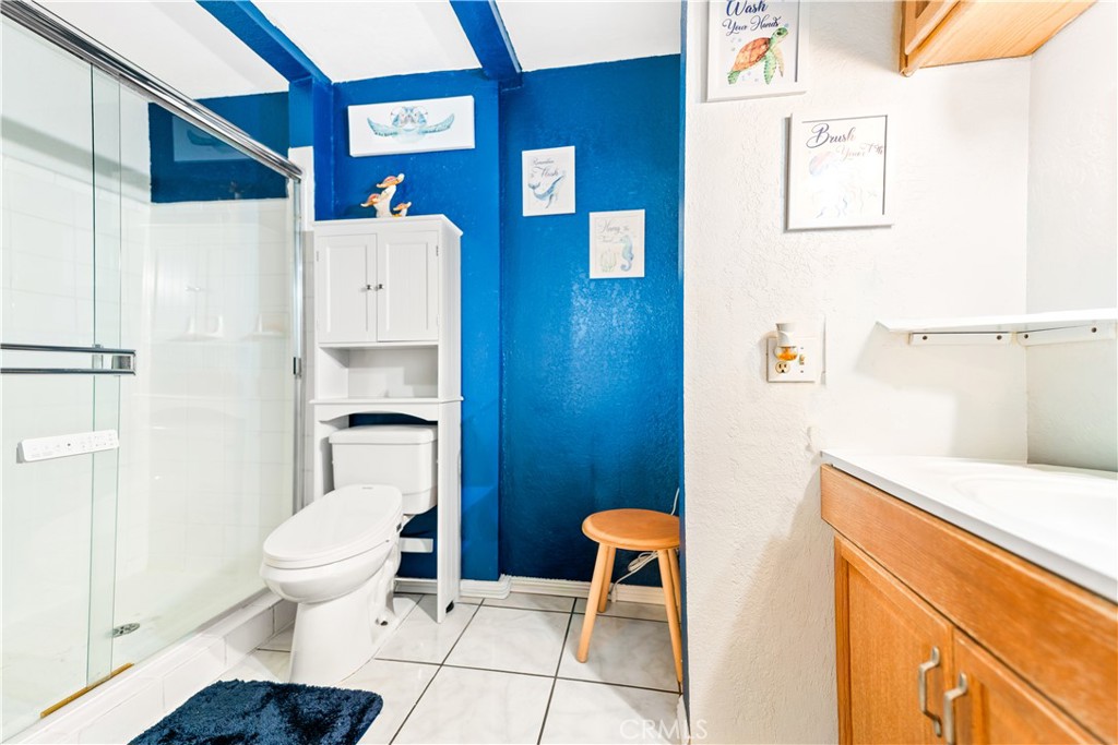 152 East Rosewood Street Rialto, CA 92376 - Photo 13 of 30 a bathroom with a toilet and a shower