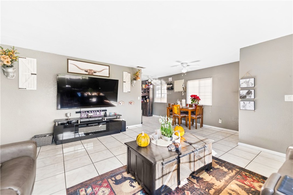 152 East Rosewood Street Rialto, CA 92376 - Photo 7 of 30 a living room with furniture and a flat screen tv