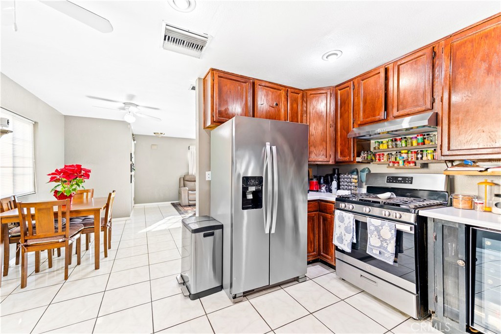 152 East Rosewood Street Rialto, CA 92376 - Photo 8 of 30 a kitchen with stainless steel appliances granite countertop a refrigerator and a stove