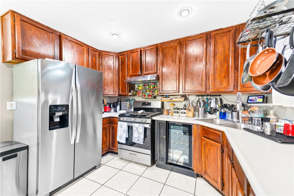 152 East Rosewood Street Rialto, CA 92376 - Photo 9 of 30 a kitchen with stainless steel appliances granite countertop a refrigerator and a stove top oven