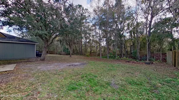 a backyard of a house with lots of green space