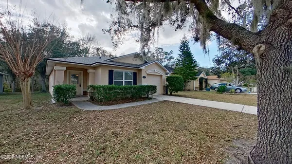 a view of a house with a tree in front