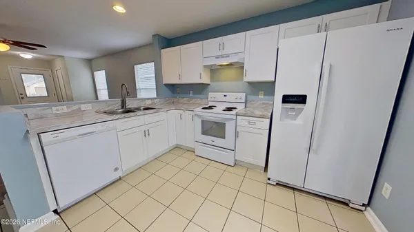a kitchen with white cabinets sink and white appliances