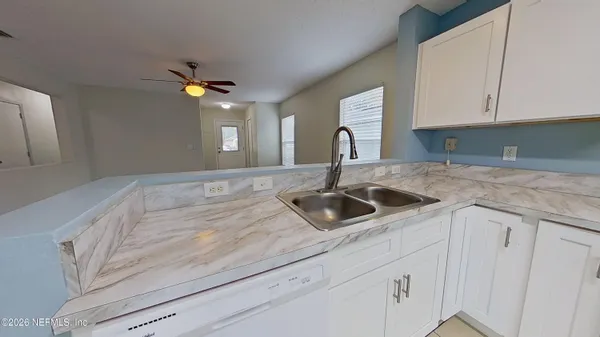 a kitchen with a sink dishwasher and cabinets