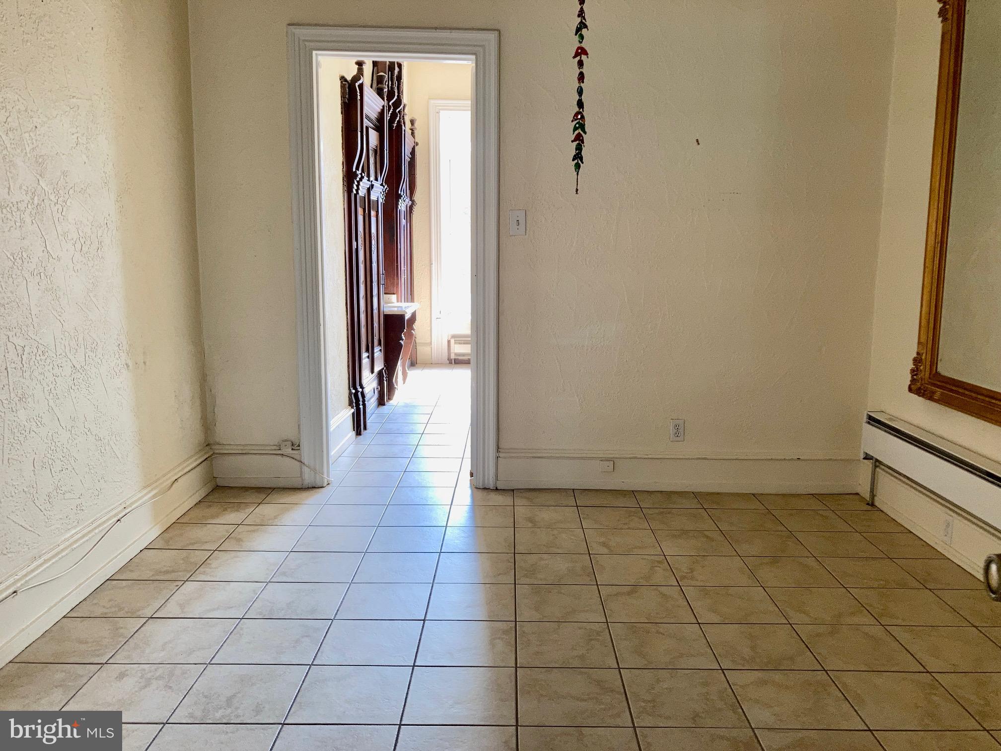 1122 South Broad Street, Unit 2R Philadelphia, PA 19146 - Photo 9 of 10 an entryway of a house and an empty room
