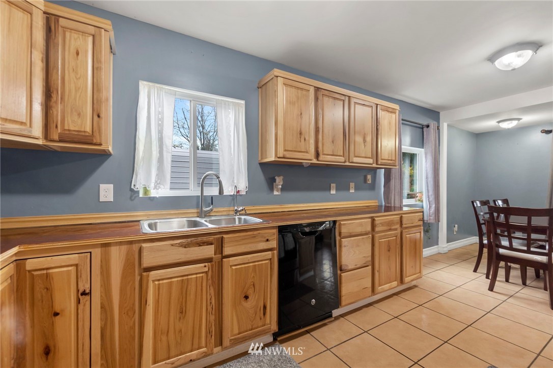 18349 Albany Street Southwest Rochester, WA 98579 - Photo 11 of 21 a kitchen with stainless steel appliances granite countertop a stove a sink and a microwave