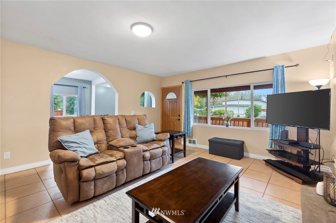 18349 Albany Street Southwest Rochester, WA 98579 - Photo 5 of 21 a living room with furniture a lamp and a large window