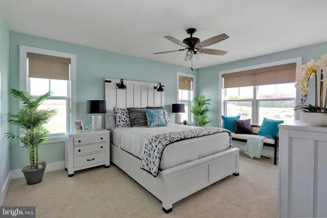 a spacious bedroom with a bed and a large window