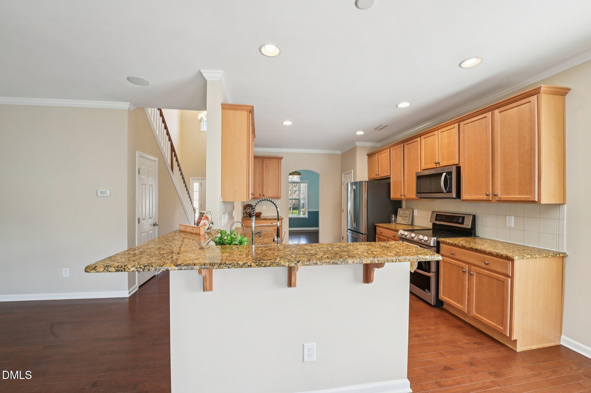11 Hidden Ridge Court Durham, NC 27707 - Photo 8 of 30 a kitchen with stainless steel appliances granite countertop a sink a stove and a refrigerator