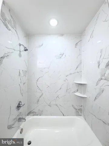 a bathroom with a bathtub and shower
