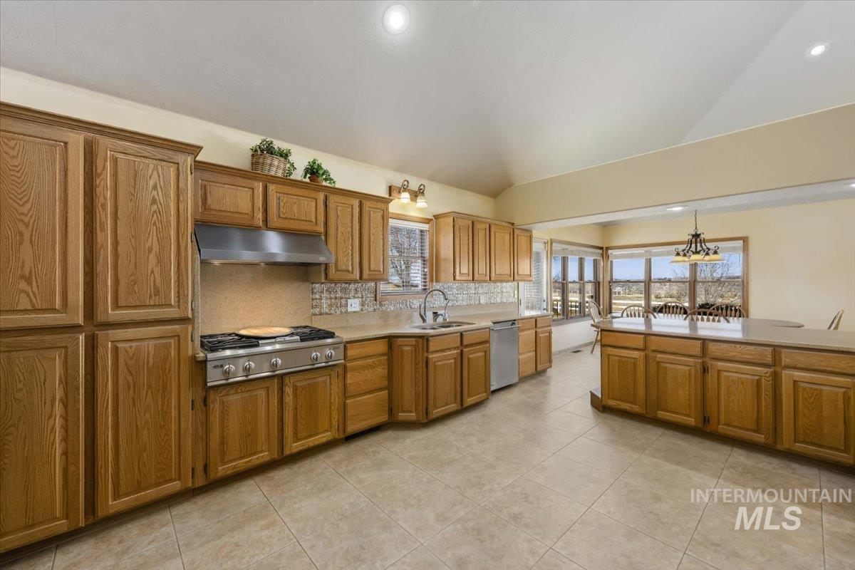 474 Kay Drive Twin Falls, ID 83301 - Photo 11 of 38 Kitchen with wood finish cabinetry, backsplash, stainless steel appliances, lofted ceiling, and hanging lights