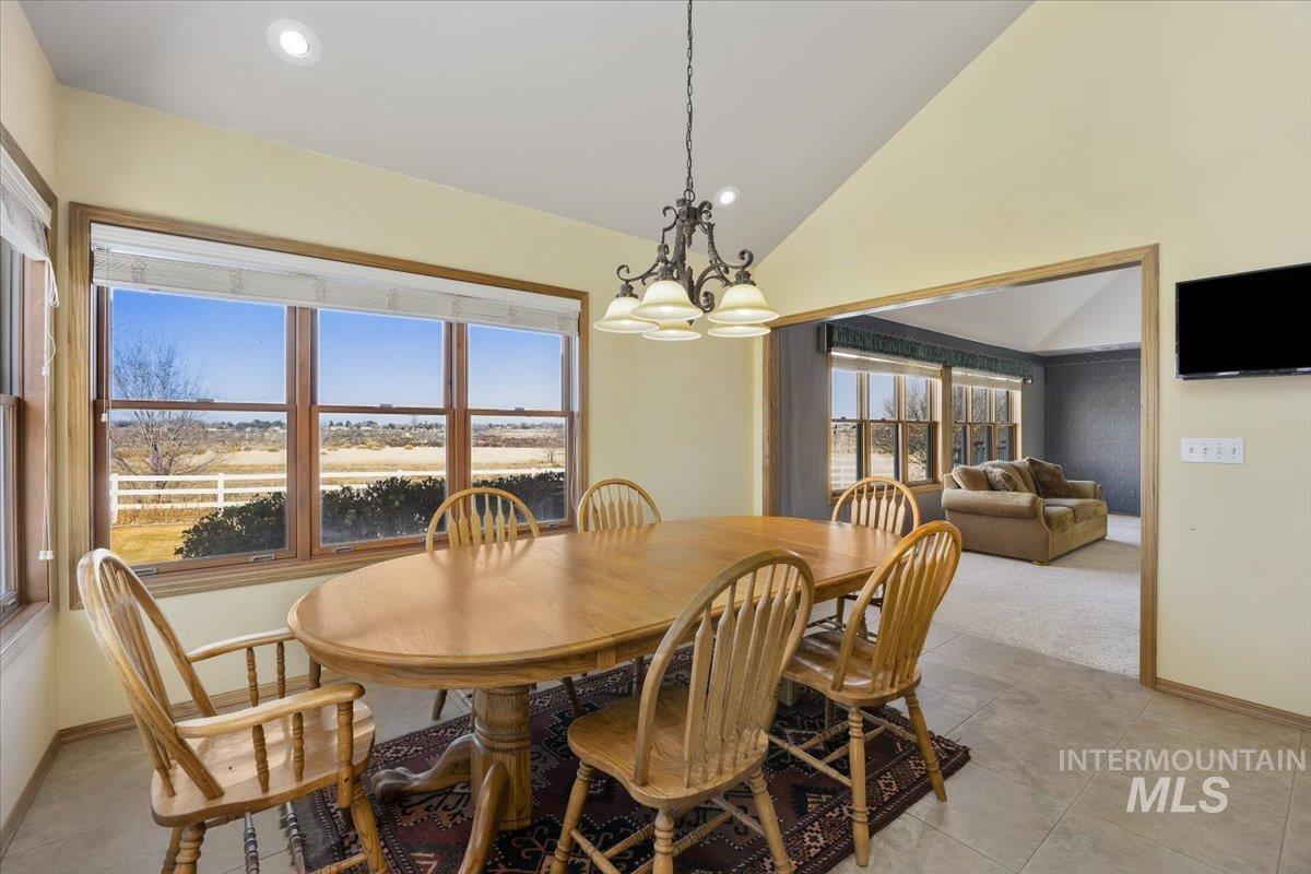 474 Kay Drive Twin Falls, ID 83301 - Photo 15 of 38 Dining space with lofted ceiling, a chandelier, and light tile patterned flooring