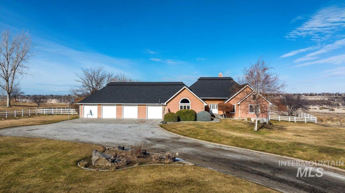 474 Kay Drive Twin Falls, ID 83301 - Photo 3 of 38 View of front of house featuring driveway, a garage, and a chimney