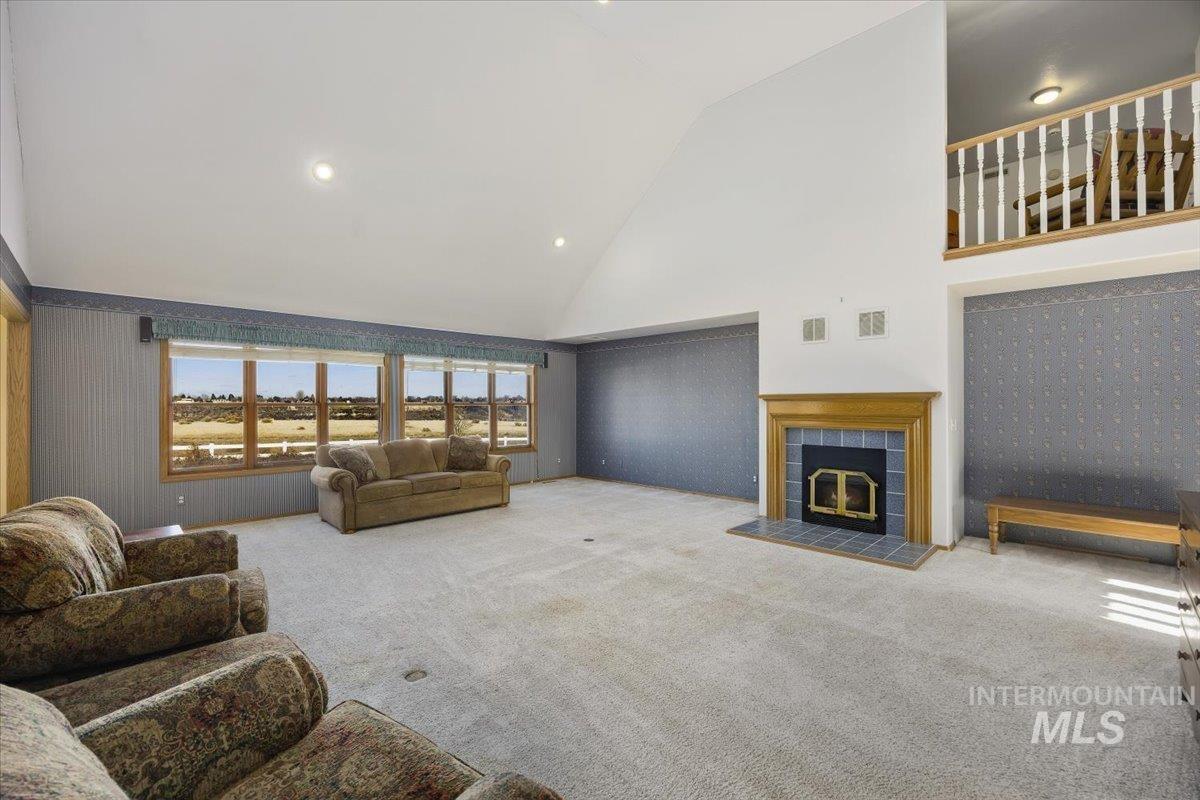 474 Kay Drive Twin Falls, ID 83301 - Photo 7 of 38 Living room featuring carpet floors, a tile fireplace, recessed lighting, and lofted ceiling