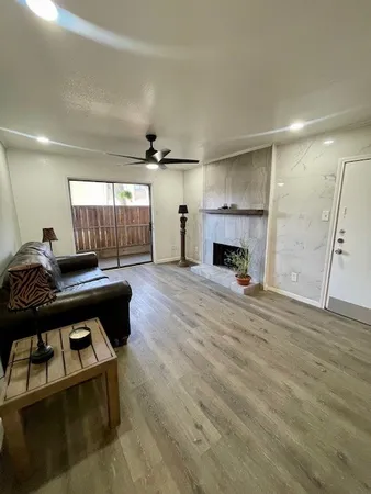 a living room with furniture and a fireplace