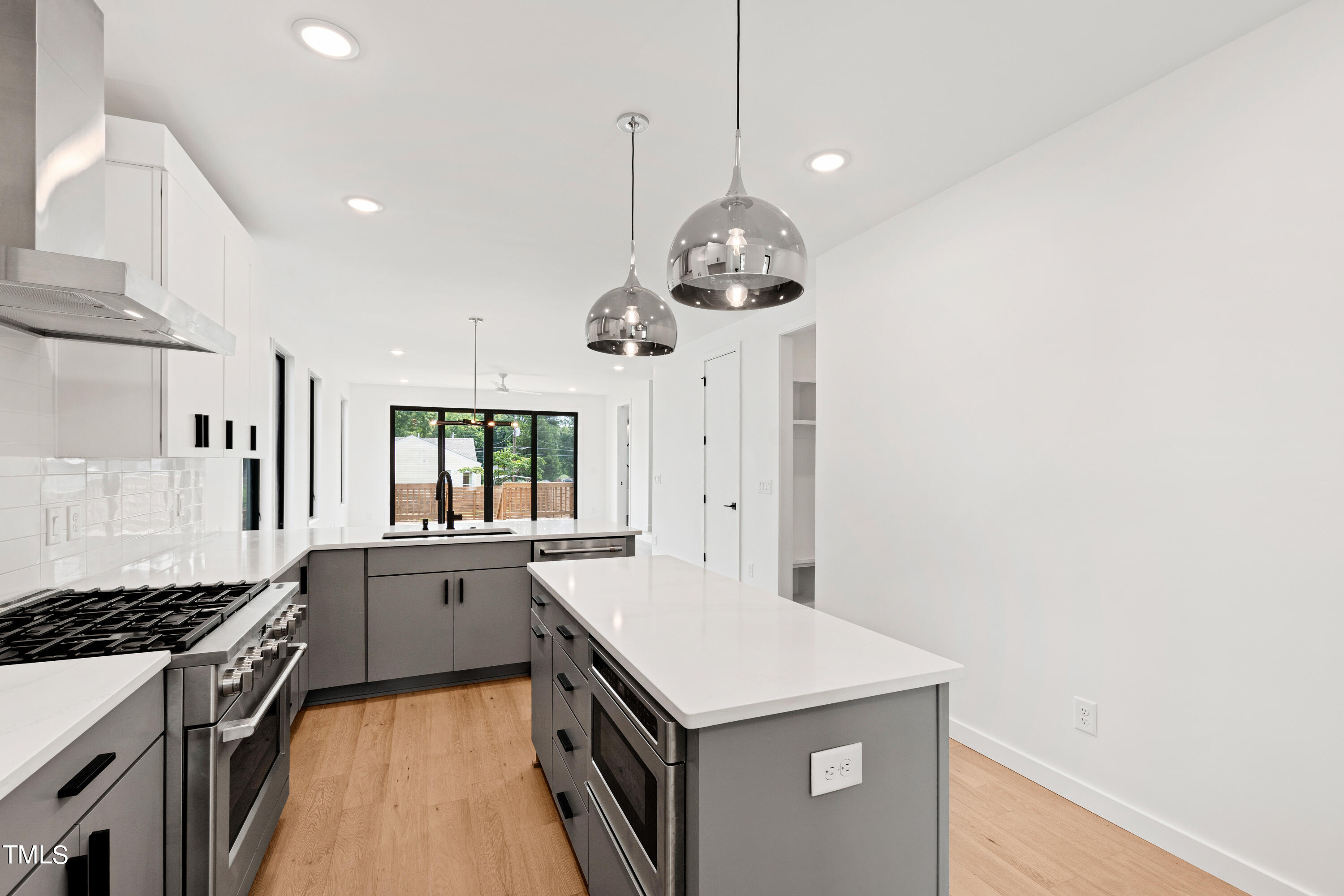716 Brighton Road, Unit 101 Raleigh, NC 27610 - Photo 15 of 67 a kitchen with a stove and a wooden floor