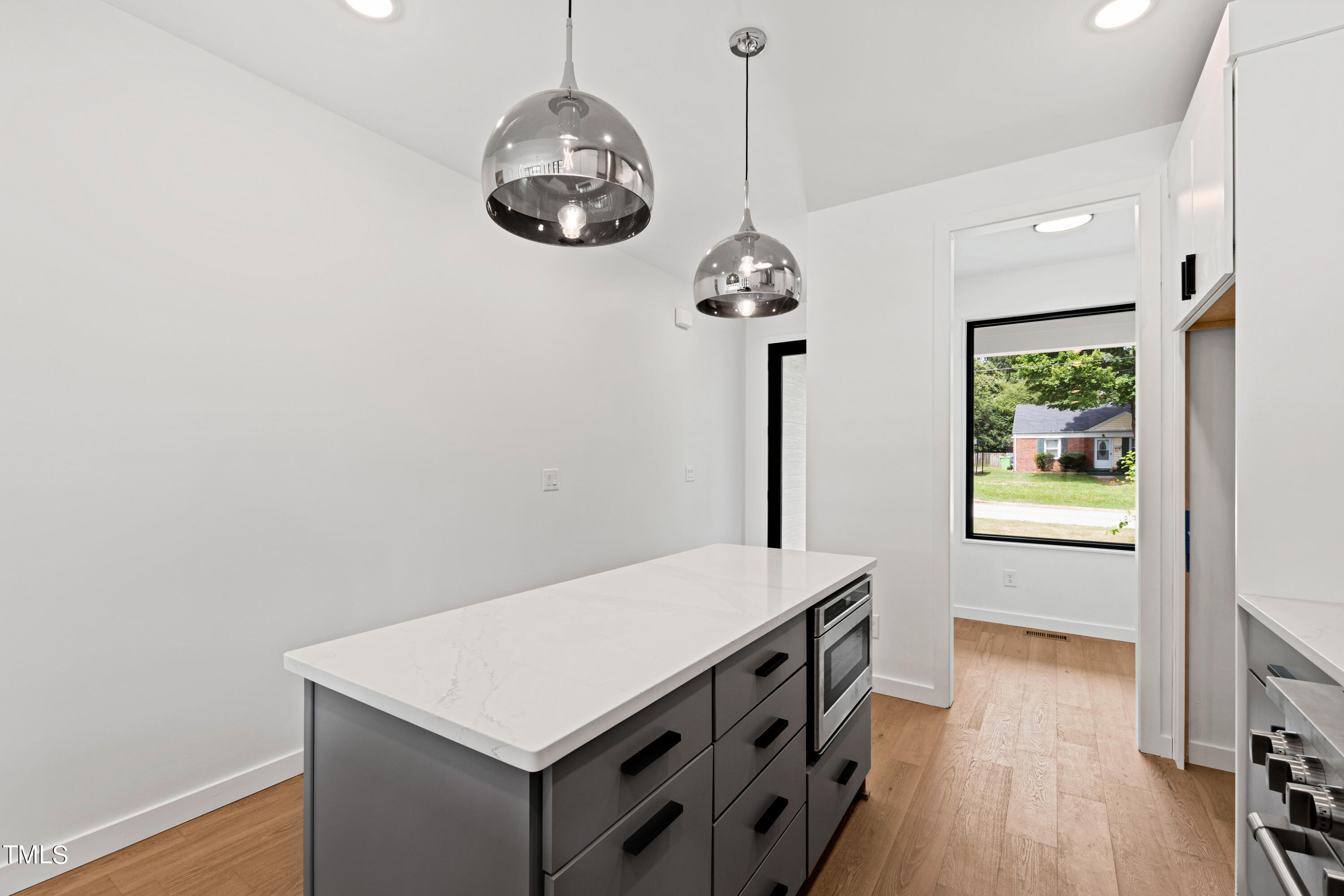 716 Brighton Road, Unit 101 Raleigh, NC 27610 - Photo 17 of 67 a kitchen with furniture and a chandelier