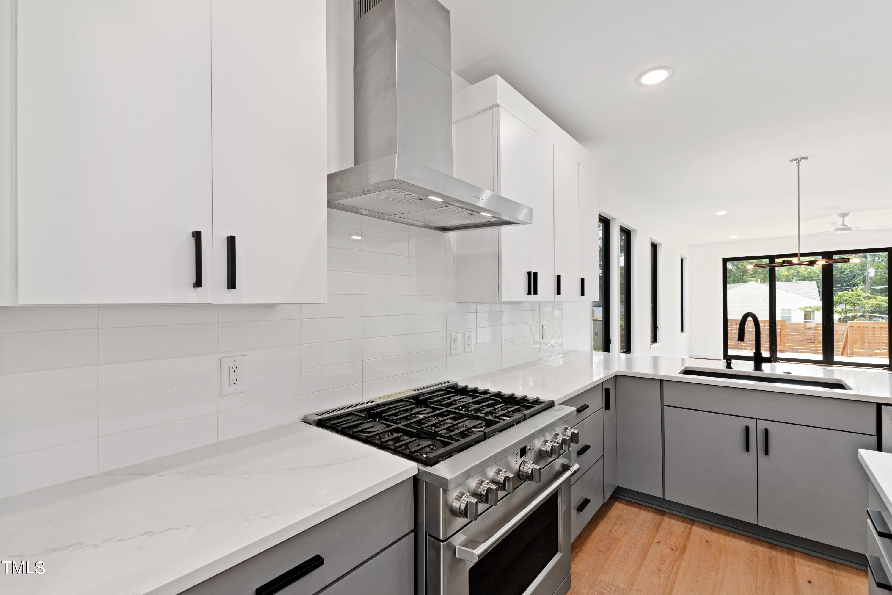 716 Brighton Road, Unit 101 Raleigh, NC 27610 - Photo 21 of 67 a kitchen with stainless steel appliances a sink a stove and white cabinets