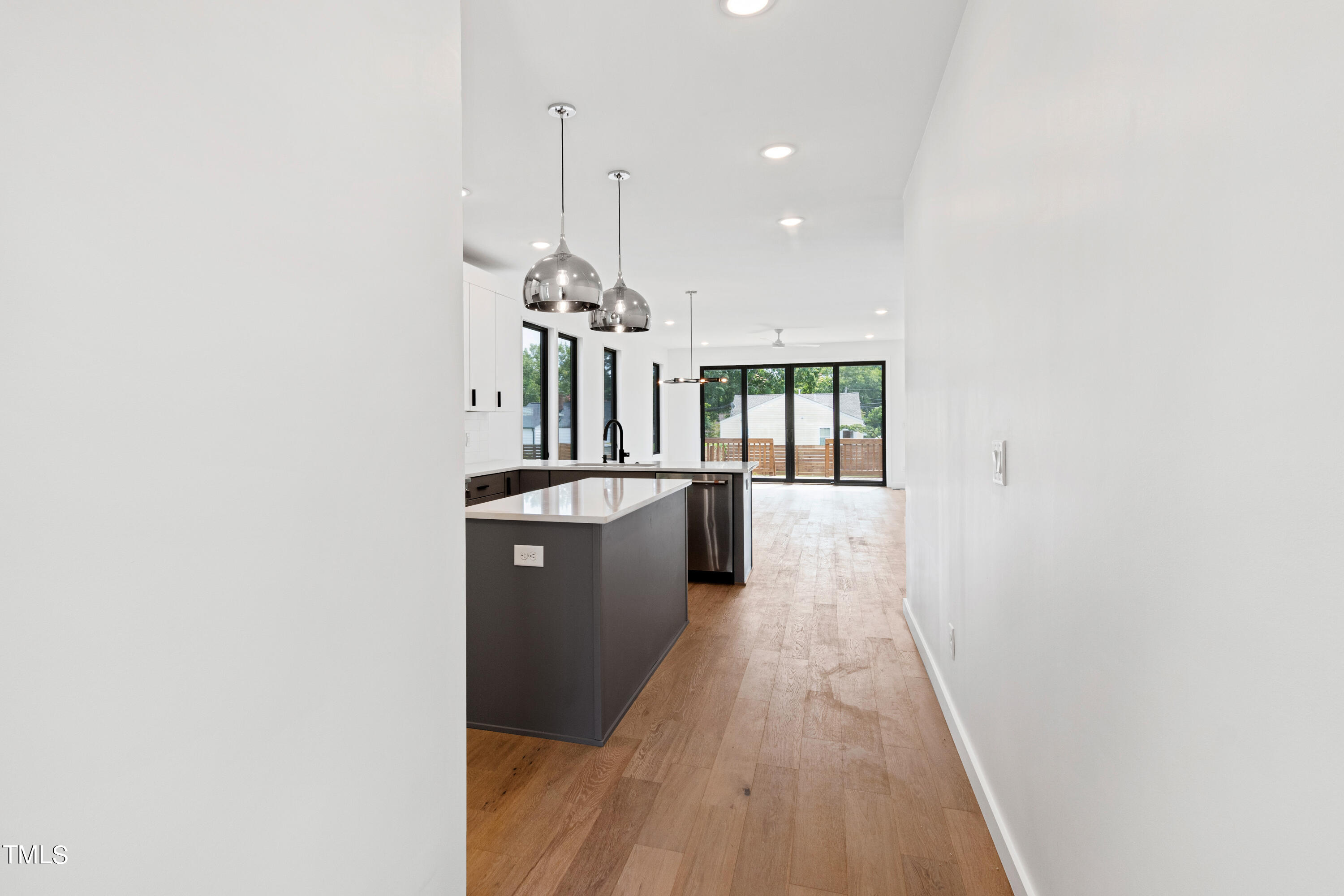 716 Brighton Road, Unit 101 Raleigh, NC 27610 - Photo 27 of 67 a view of a hallway with wooden floor and a chandelier