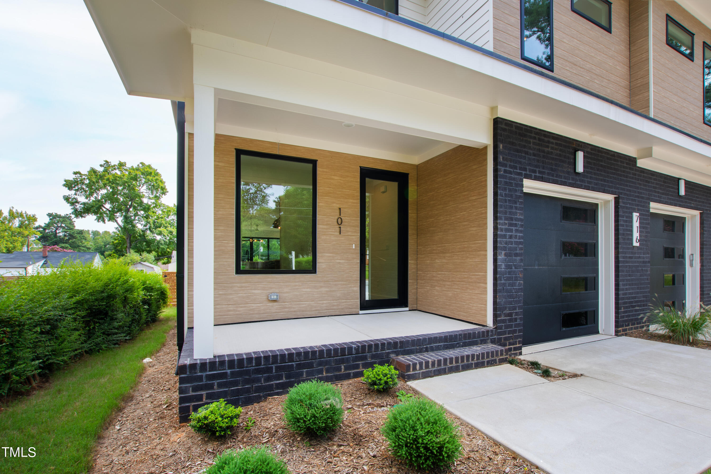 716 Brighton Road, Unit 101 Raleigh, NC 27610 - Photo 3 of 67 a front view of a house with a yard