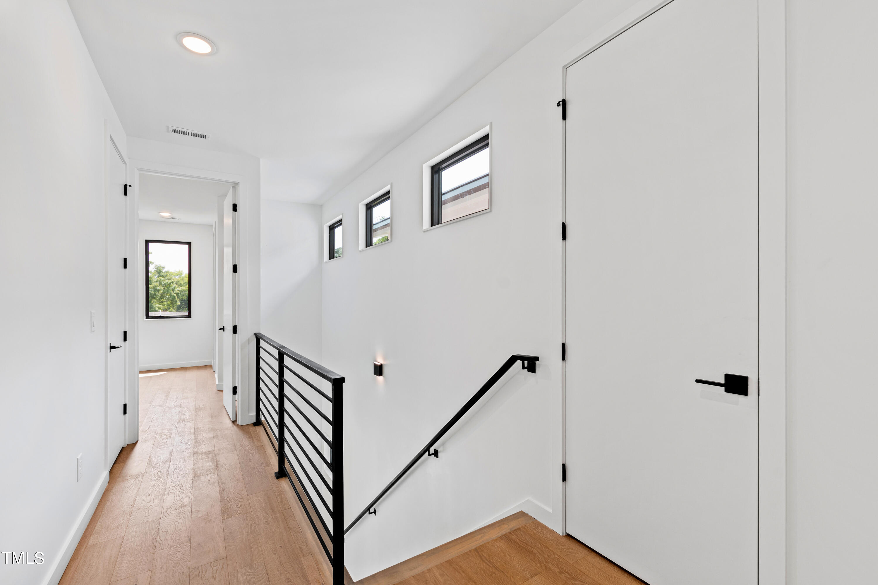 716 Brighton Road, Unit 101 Raleigh, NC 27610 - Photo 32 of 67 a view of a hallway with the entryway and wooden floor