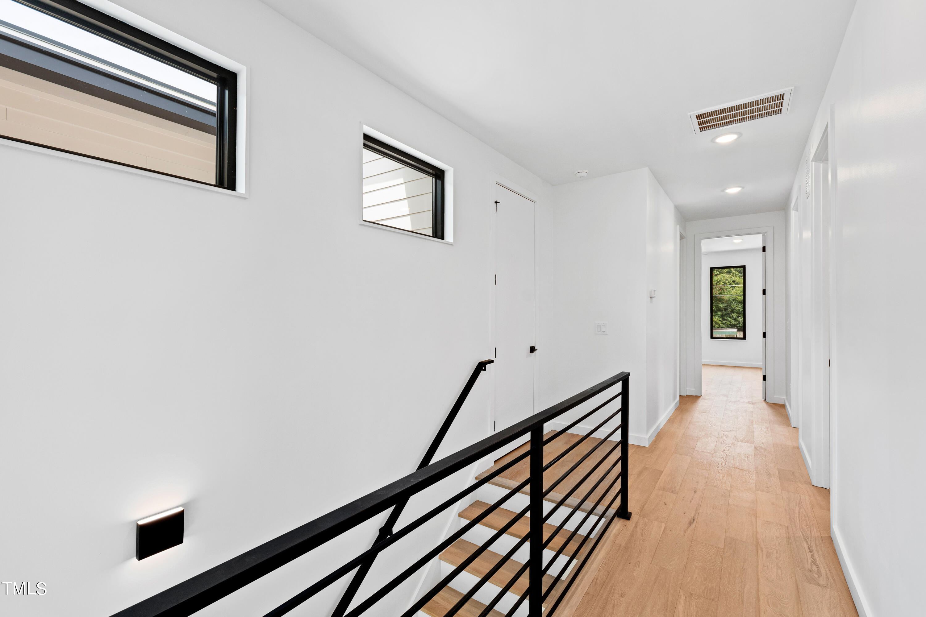 716 Brighton Road, Unit 101 Raleigh, NC 27610 - Photo 34 of 67 a view of a hallway with wooden floor
