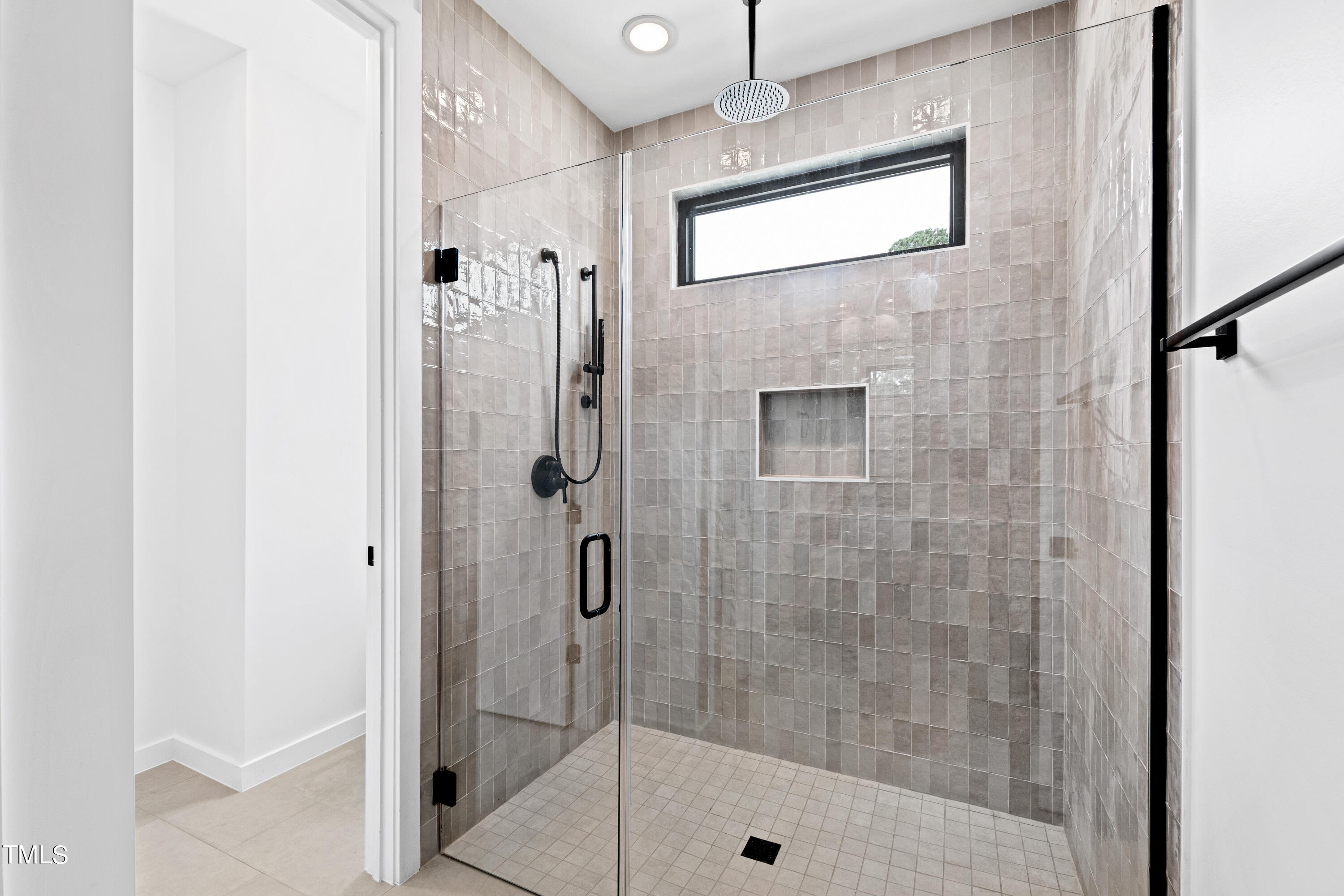 716 Brighton Road, Unit 101 Raleigh, NC 27610 - Photo 39 of 67 a bathroom with a shower and a glass door