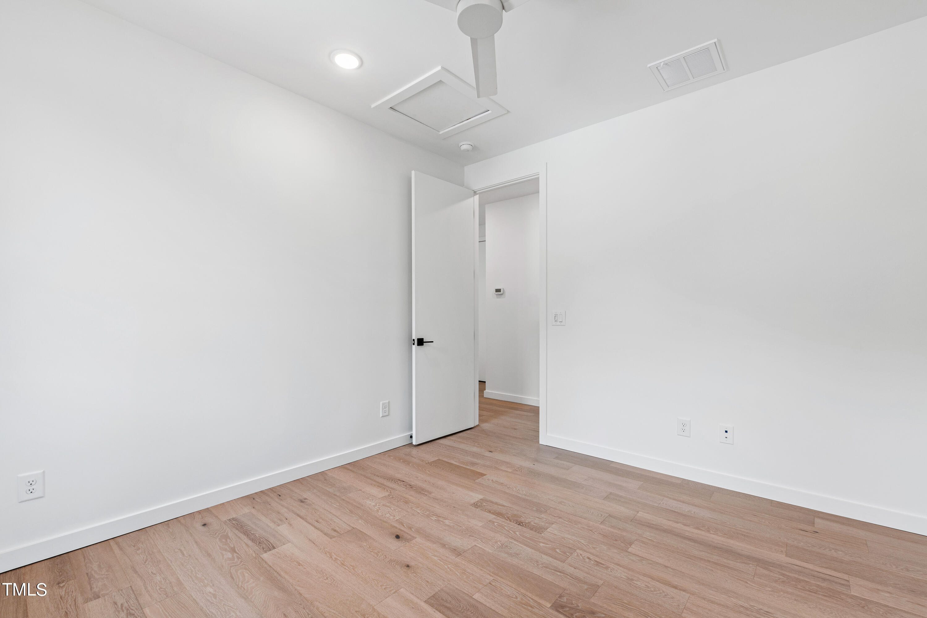 716 Brighton Road, Unit 101 Raleigh, NC 27610 - Photo 48 of 67 a view of an empty room with wooden floor