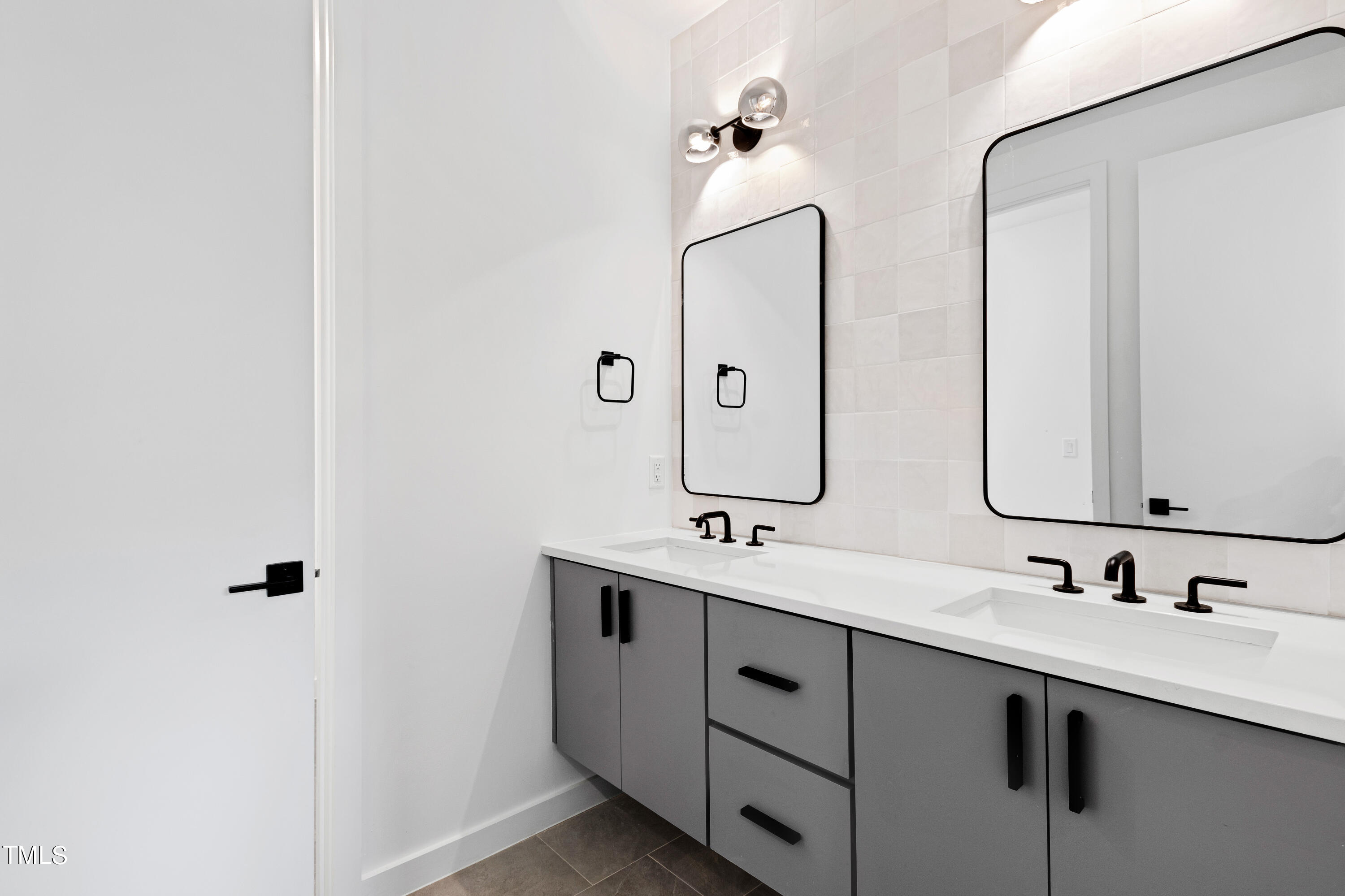 716 Brighton Road, Unit 101 Raleigh, NC 27610 - Photo 49 of 67 a bathroom with a double vanity sink and mirror