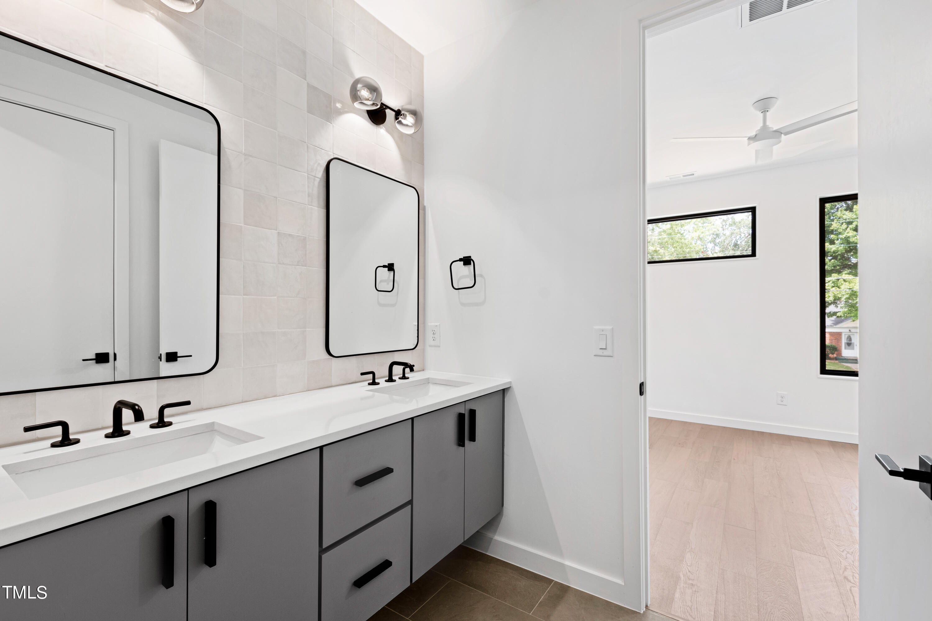 716 Brighton Road, Unit 101 Raleigh, NC 27610 - Photo 51 of 67 a bathroom with a double vanity sink and mirror