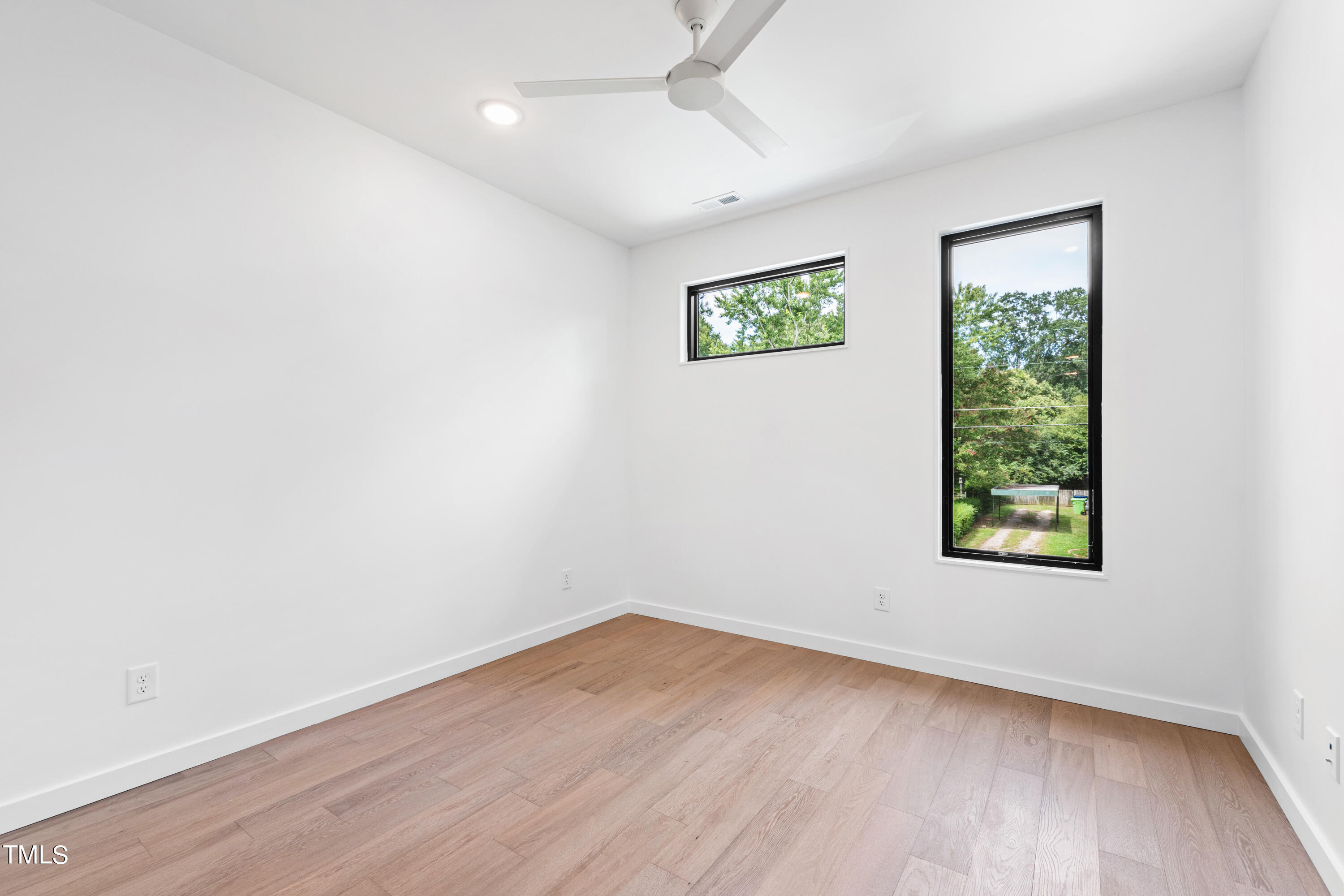 716 Brighton Road, Unit 101 Raleigh, NC 27610 - Photo 57 of 67 wooden floor in an empty room with a window