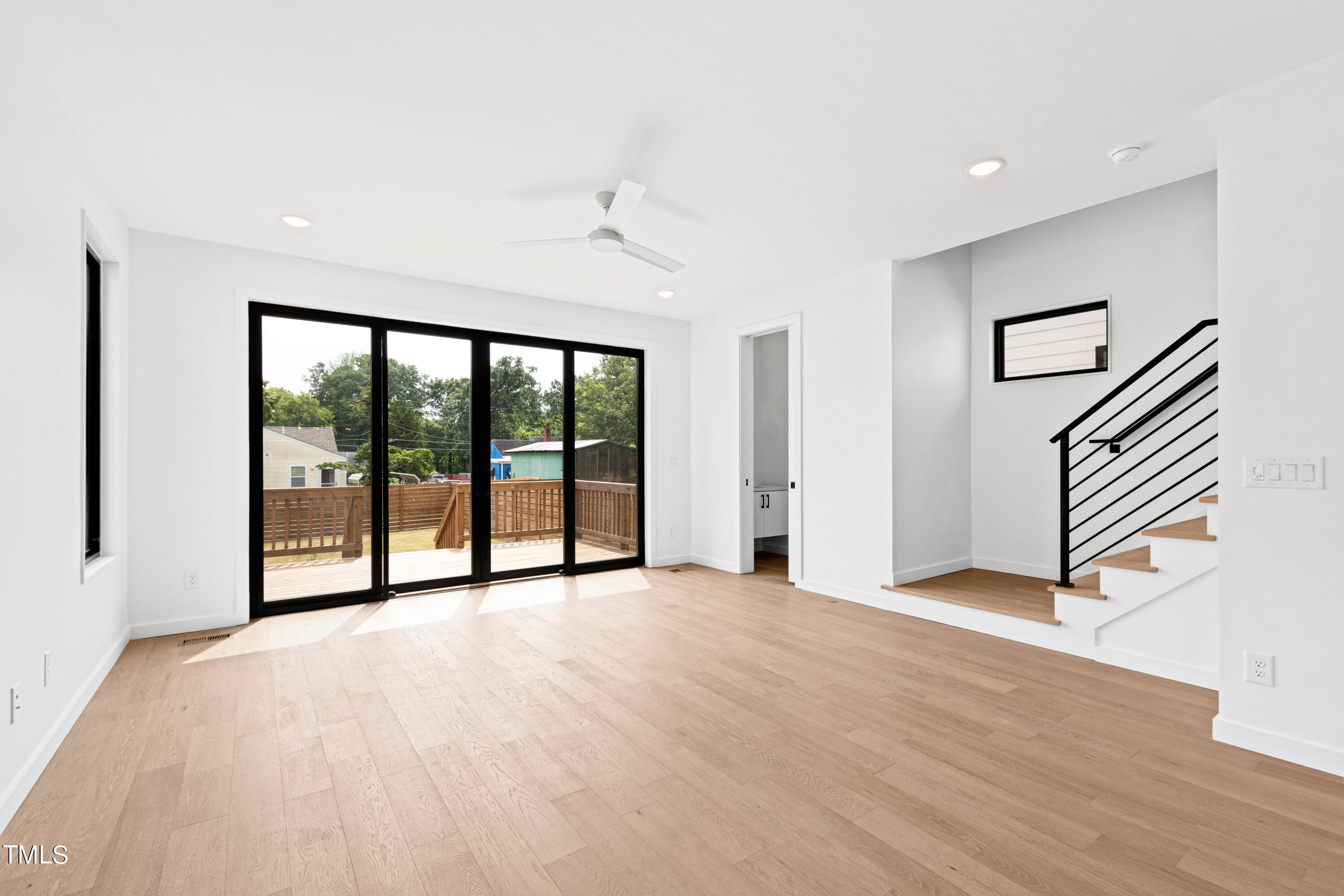 716 Brighton Road, Unit 101 Raleigh, NC 27610 - Photo 6 of 67 a view of an empty room with wooden floor and a window