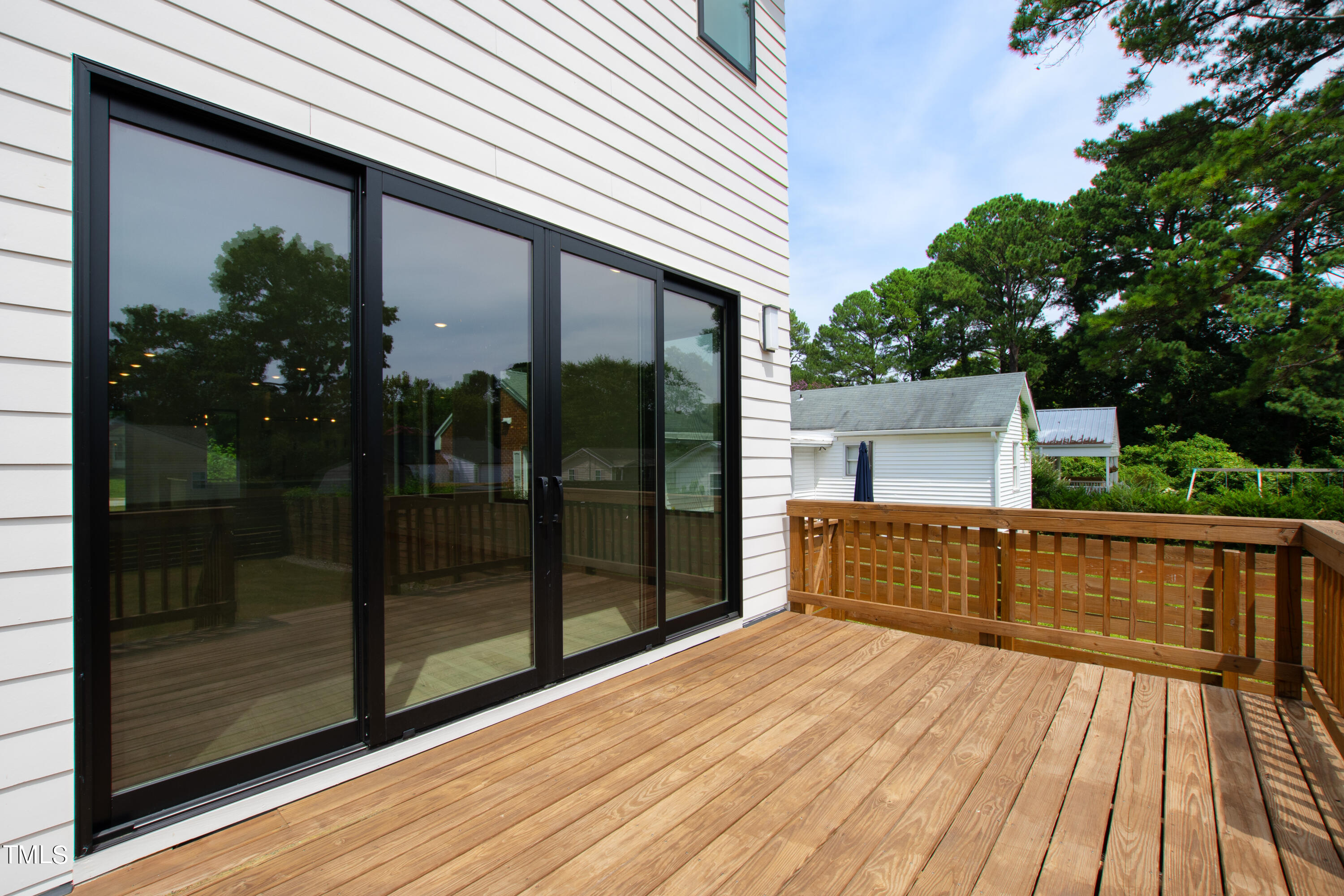 716 Brighton Road, Unit 101 Raleigh, NC 27610 - Photo 63 of 67 a view of a house with a wooden deck