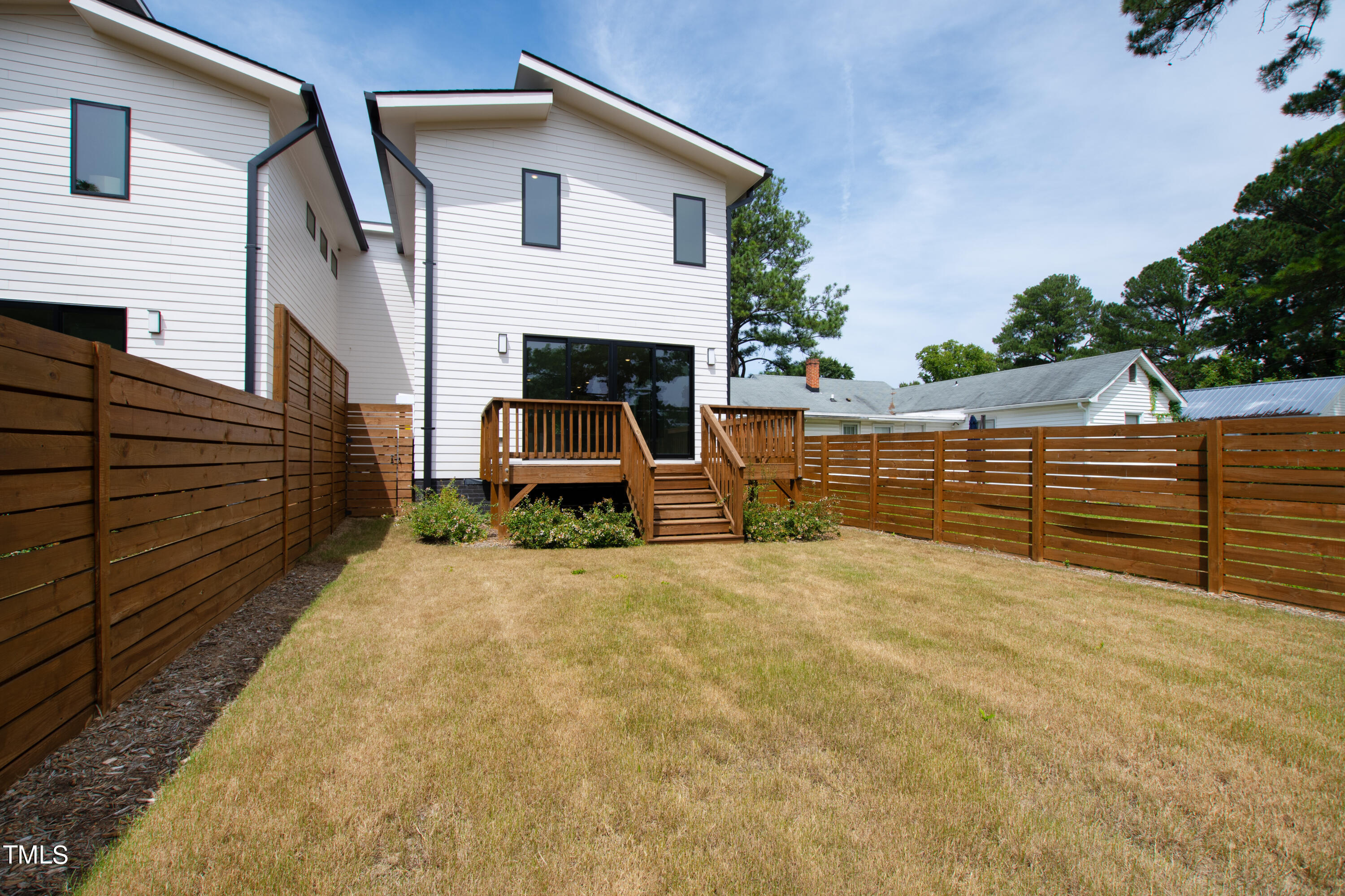 716 Brighton Road, Unit 101 Raleigh, NC 27610 - Photo 65 of 67 a view of a house with backyard and porch