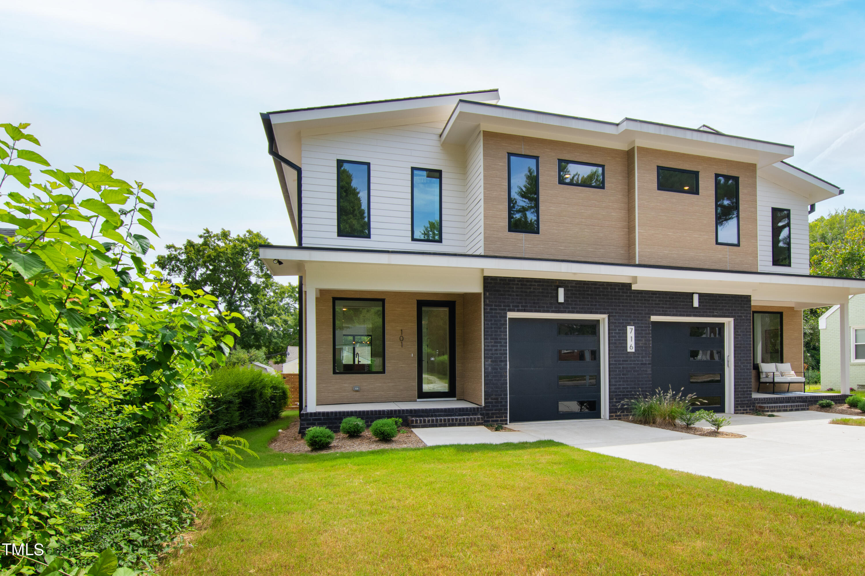 716 Brighton Road, Unit 101 Raleigh, NC 27610 - Photo 67 of 67 a front view of a house with a yard and garage