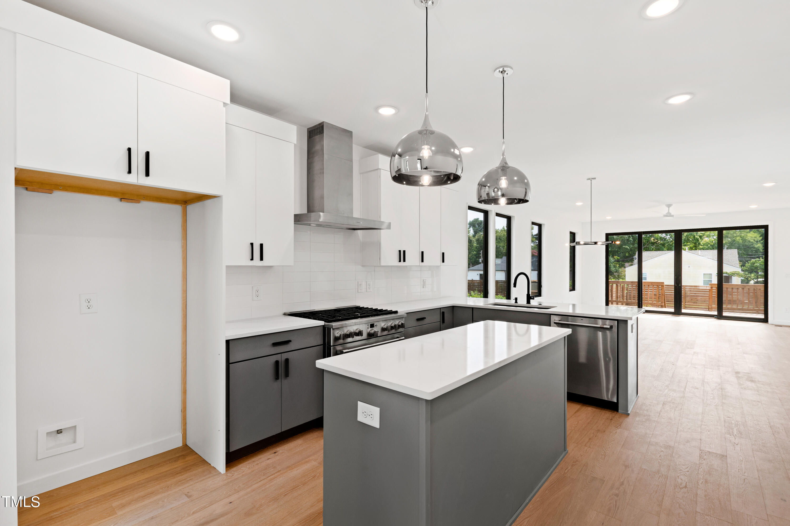 716 Brighton Road, Unit 101 Raleigh, NC 27610 - Photo 8 of 67 a kitchen with stainless steel appliances granite countertop a sink a stove and a wooden floors