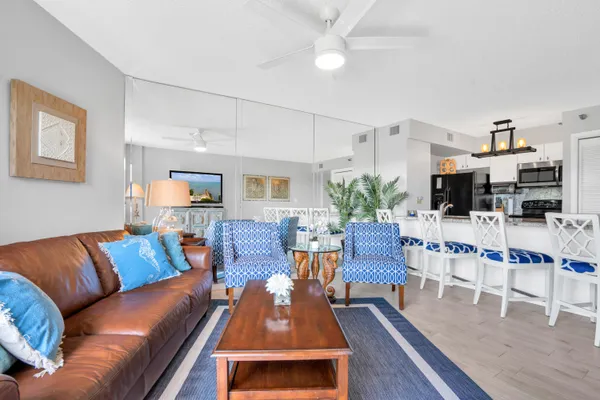 a living room with kitchen island granite countertop furniture and a fireplace